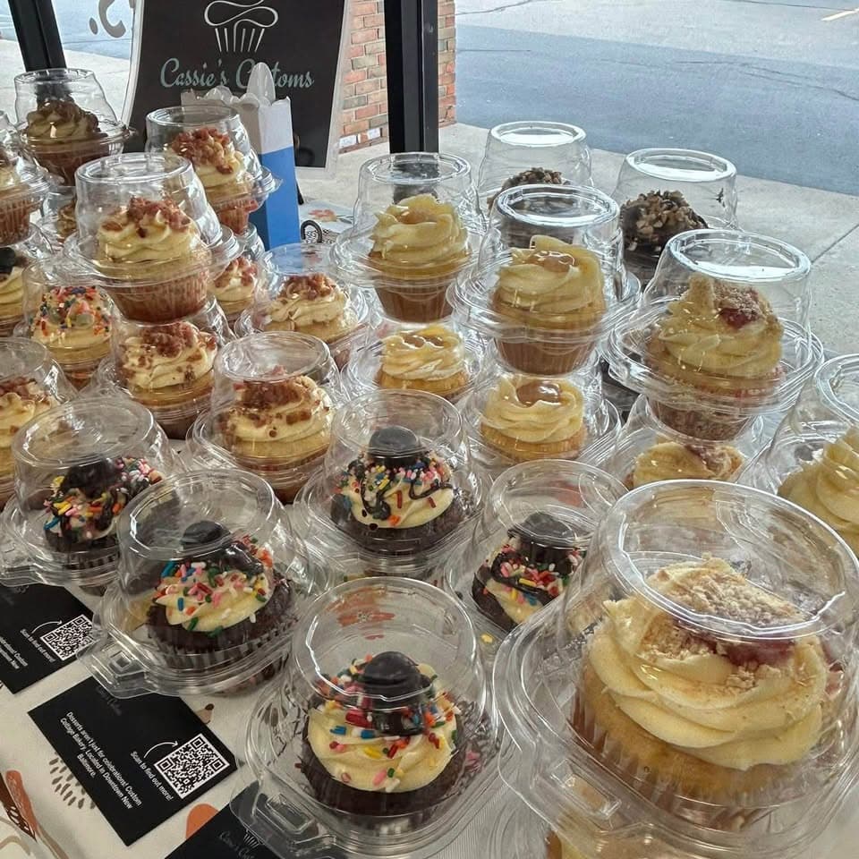 Assorted Cassie's Customs cupcakes packaged and ready for pickup