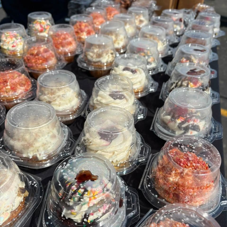 Rows of custom Cassie's Customs cupcakes